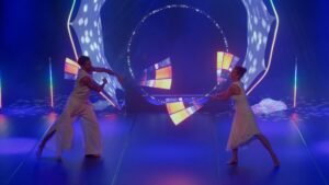 Duo de jongleurs de pixel poi affichant des graphismes numériques.