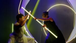 Duo performers demonstrating perfect synchronicity with programmable pixel staffs.