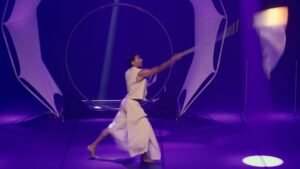 Dynamic LED rope dart performance with long-exposure light trails.