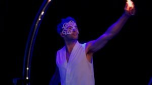 Solo narrative circus performer using light to tell a story of connection.