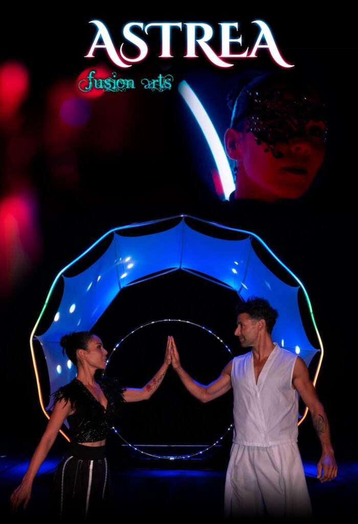 Official poster for Astrea featuring a duo of artists connecting before an LED arch, with the masked character Kali in the background.