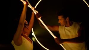 Monumental LED arch scenography symbolizing cosmic equilibrium.