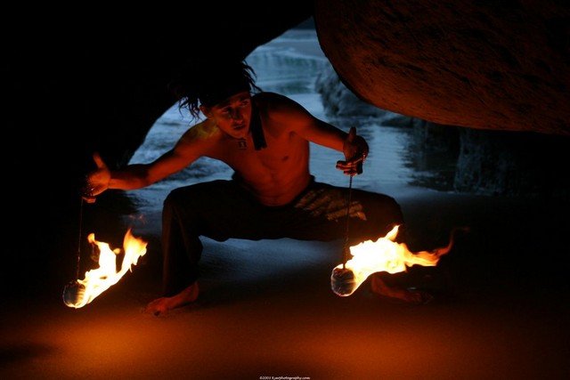 Fire poi artist in ocean cave